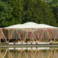On display is part of the Floating University, which is decorated with the signs, "What would you ask the audience?"