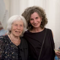 Portrait of Annemie Vanackere and Nele Hertling, smiling at the camera.