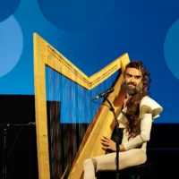 Musician Hans Unstern performing on the harp.